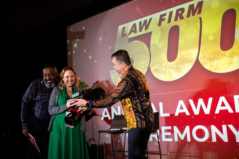 AG Immigration Law PA receiving its 2026 Law Firm 500 award on stage