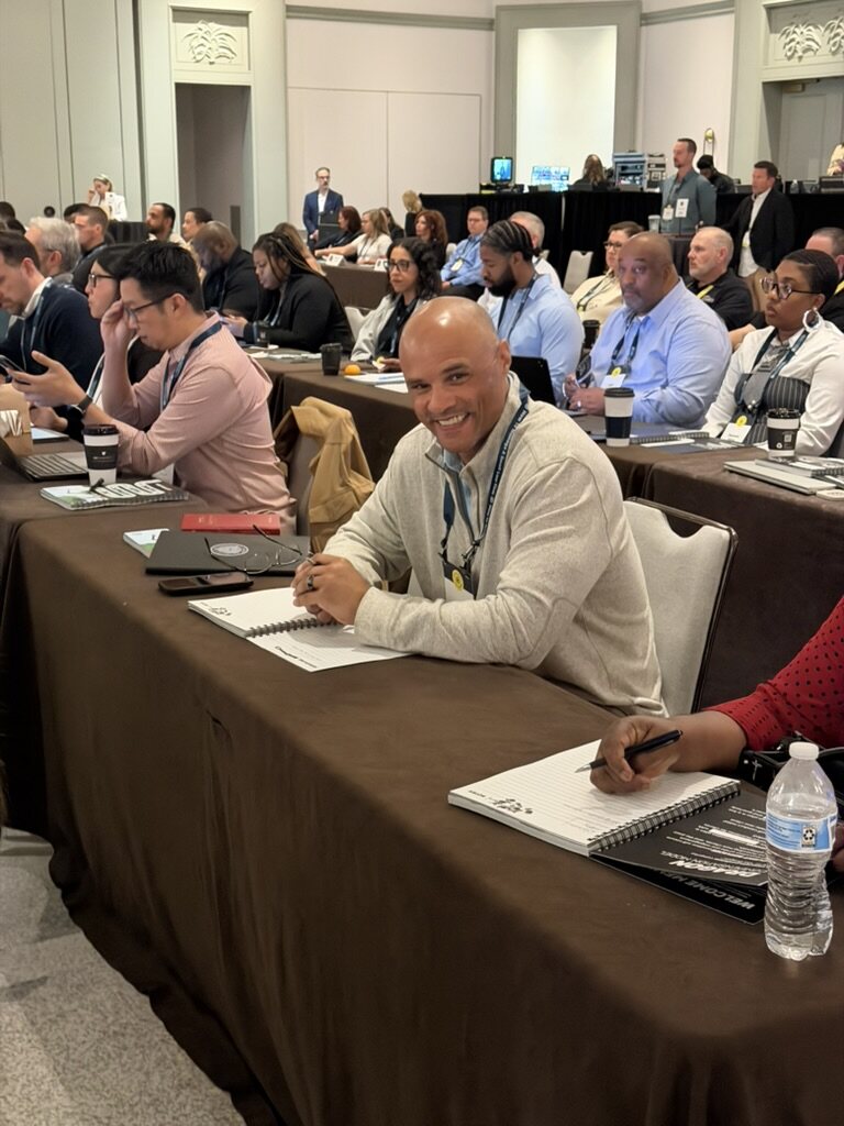 Smiling HTM member seated at a How To Manage A Small Law Firm event