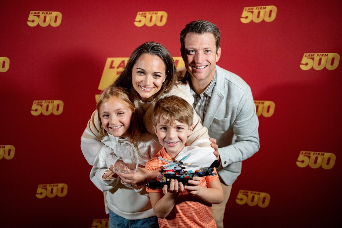Just Well Law celebrating its number one 2026 Law Firm 500 award with family