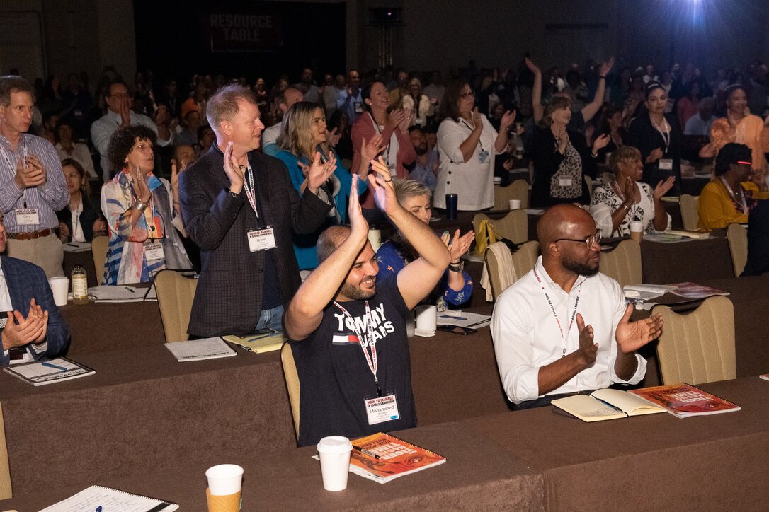 Law firm owners applauding together at a How To Manage A Small Law Firm event
