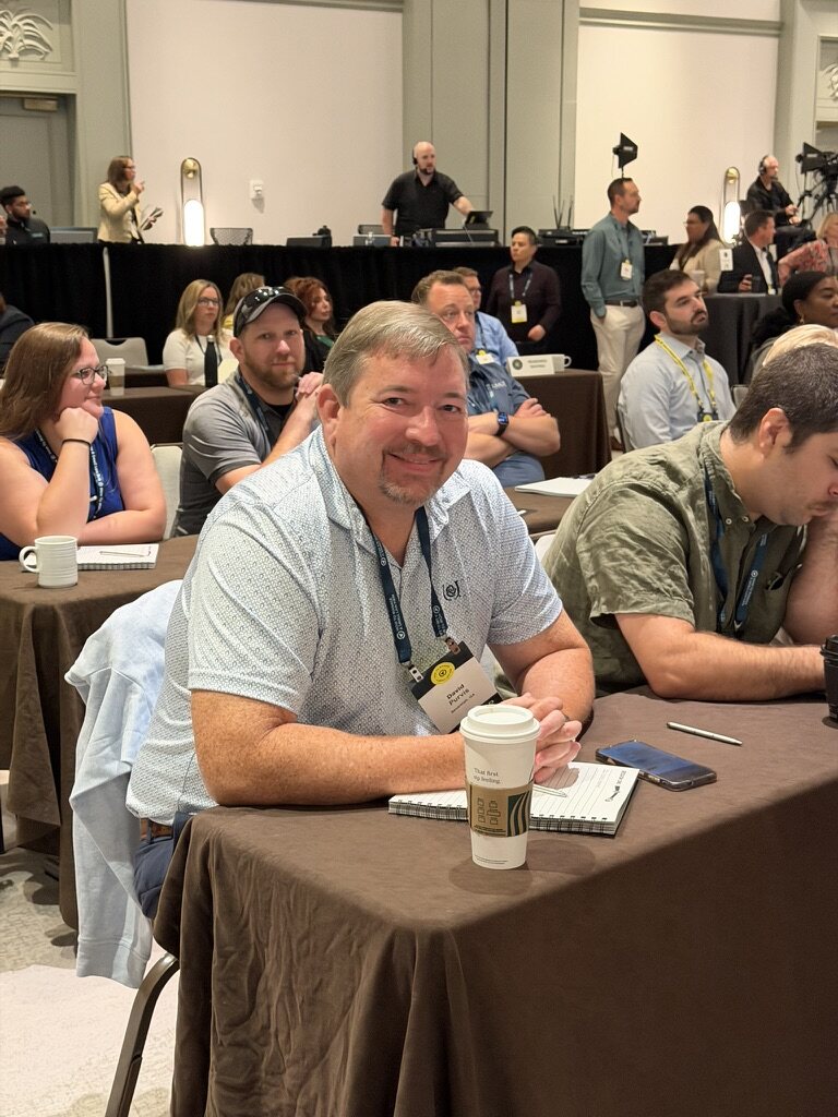 Smiling HTM members seated and ready for a live session