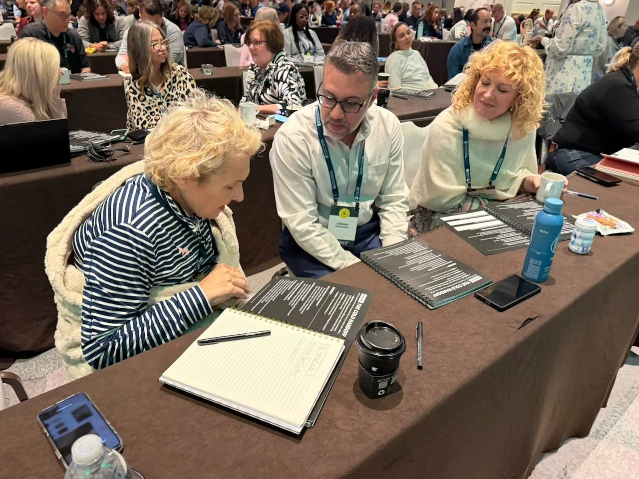 Members working together around a tablet during an HTM workshop.