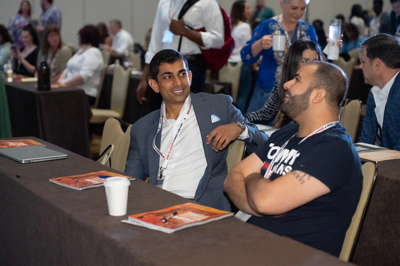 Two law firm owners talking together at an HTM member workshop.